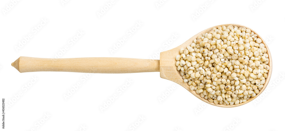 top view of polished Sorghum groats in wood spoon top view of polished Sorghum groats in wood spoon