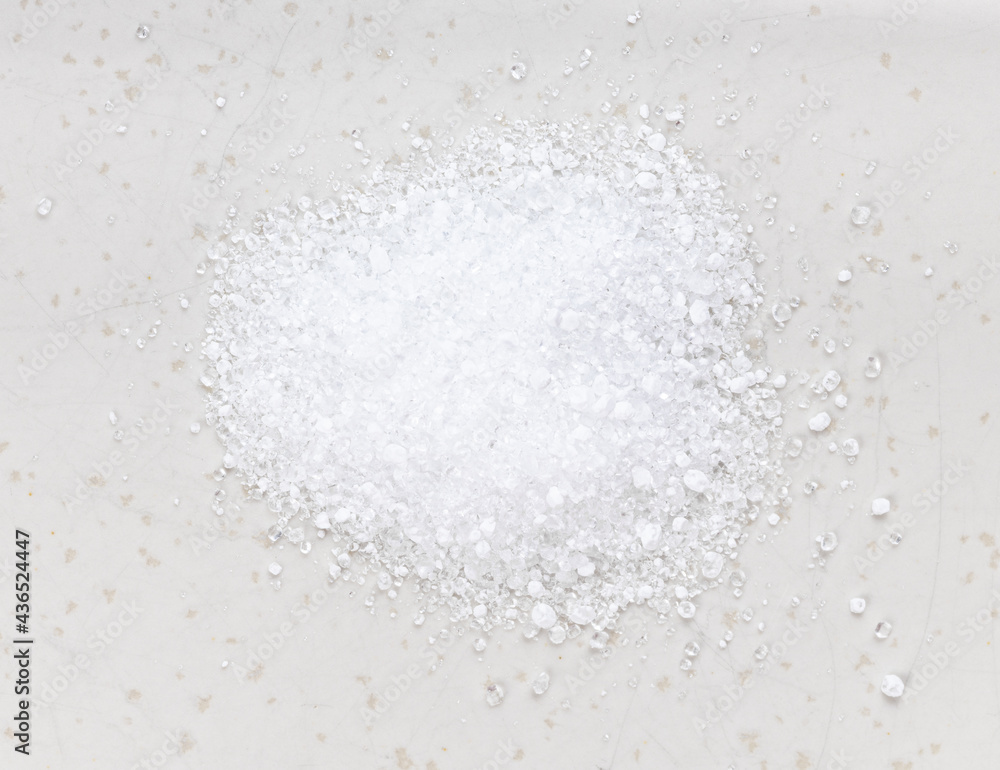 pile of crystalline citric acid close up on gray