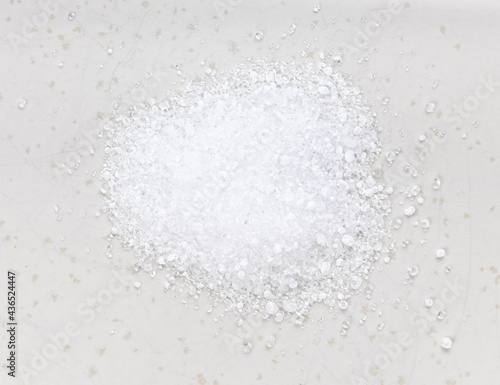 pile of crystalline citric acid close up on gray