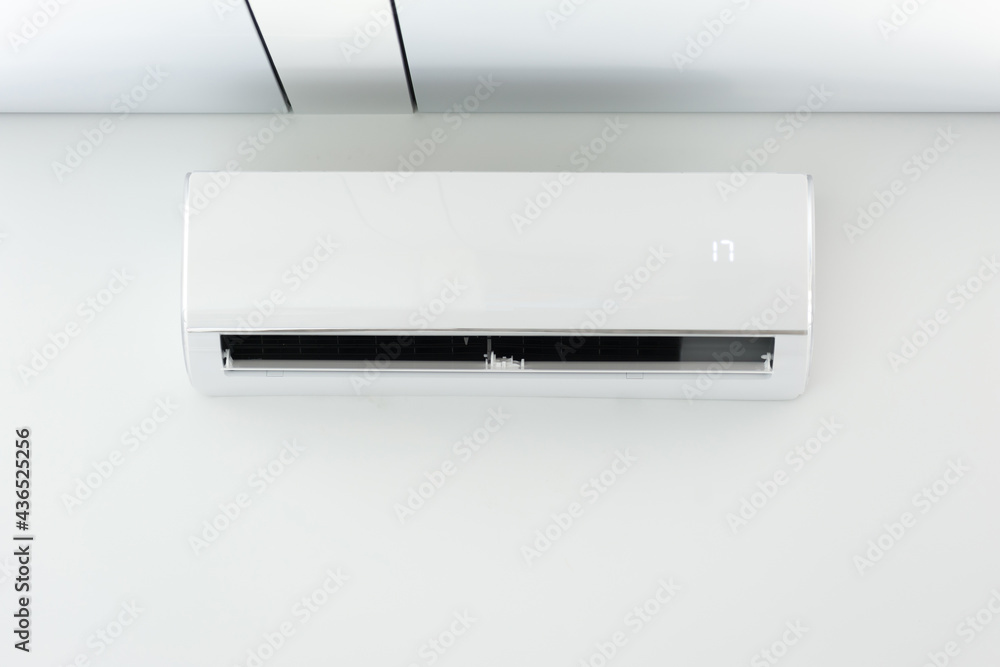 A new air conditioner unit on the white wall A new air conditioner unit on the white wall