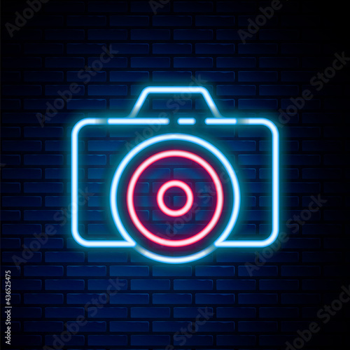 Glowing neon line Photo camera icon isolated on brick wall background. Foto camera icon. Colorful outline concept. Vector