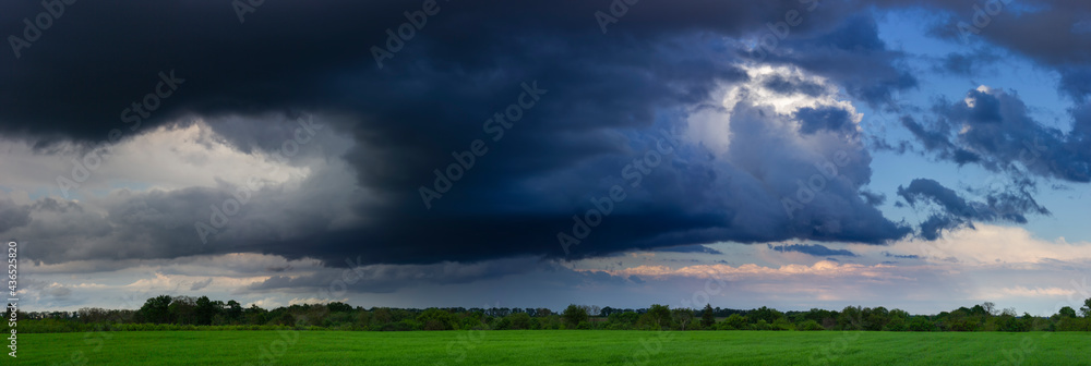 Fototapeta premium Dramatic clouds, field and sky with dark clouds.