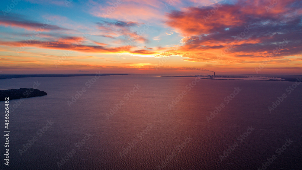 Beautiful sunrise or sunset near the sea. Photo from a drone. Pink sky. background image