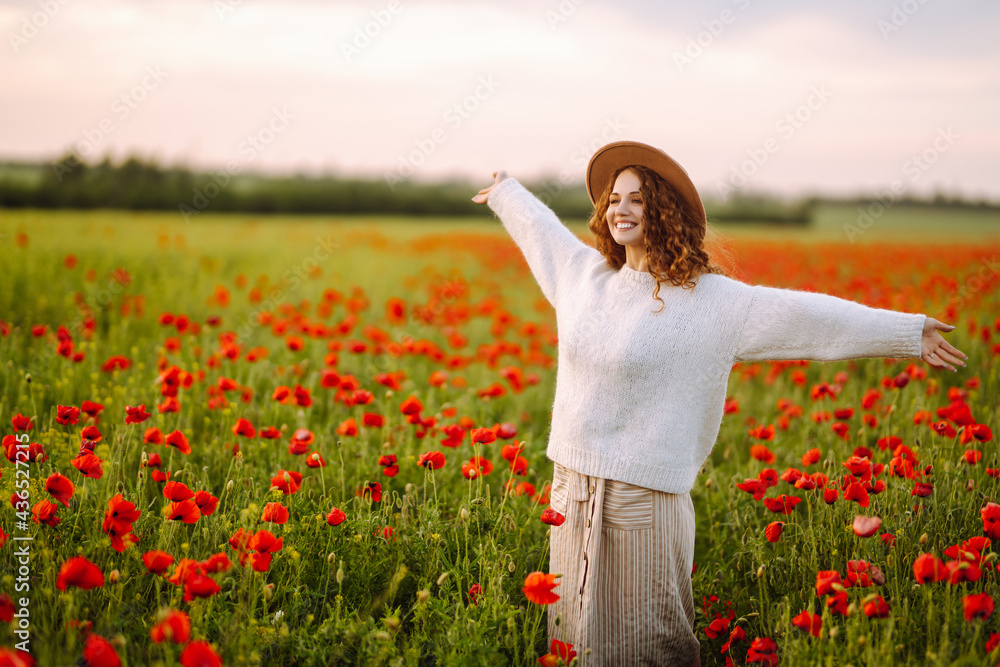 Young woman walking in amazing poppy field. Summertime. Beautiful woman posing in the blooming poppy field. Nature, vacation, relax and lifestyle. Young woman walking in amazing poppy field. Summertime. Beautiful woman posing in the blooming poppy field. Nature, vacation, relax and lifestyle.