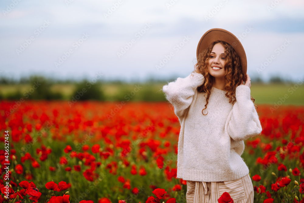 Young woman walking in amazing poppy field. Summertime. Beautiful woman posing in the blooming poppy field. Nature, vacation, relax and lifestyle. Young woman walking in amazing poppy field. Summertime. Beautiful woman posing in the blooming poppy field. Nature, vacation, relax and lifestyle.