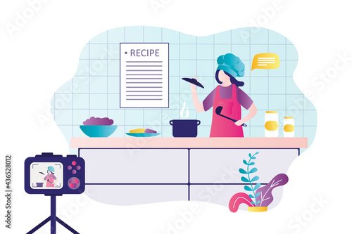 Woman chef filming process of preparing different dishes. Girl in uniform cooking in kitchen. Female character records content for blog.