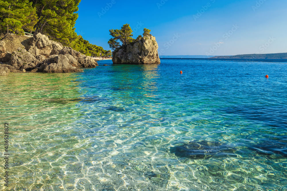 Small rock island and transparent sea in Dalmatia, Brela, Croatia