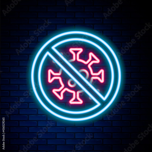 Glowing neon line Stop virus icon isolated on brick wall background. Corona virus 2019-nCoV. Bacteria and germs, cell cancer, microbe, fungi. Colorful outline concept. Vector