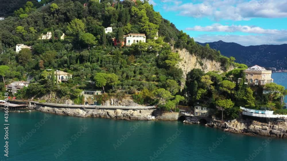 Aerial view with a drone of Portofino in Italy. We can see houses in the middle of a forest in a mountain under the sunlight 4K Aerial view with a drone of Portofino in Italy. We can see houses in the middle of a forest in a mountain under the sunlight 4K