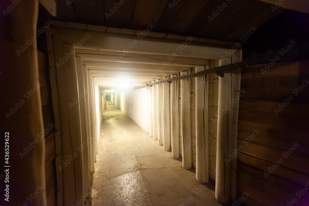 Empty illuminated long tunnels in old mines