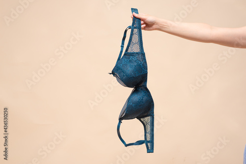 Woman is showing a new bra in the hand. Choosing a new bra concept.