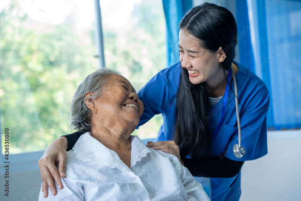 Obraz premium Young woman doctor or nurse assist take care and give help support old lady patient at hospital,geriatrics eldercare concept.