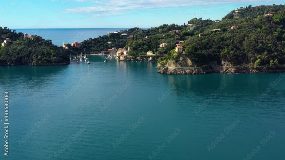 The coast of Portofino in Italy. We can see the blue water near the mountain under the sunlight 4K The coast of Portofino in Italy. We can see the blue water near the mountain under the sunlight 4K