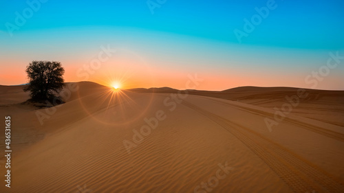 Photography Beautiful Sunrise at desert including sand pattern with sun and shine and sun ring