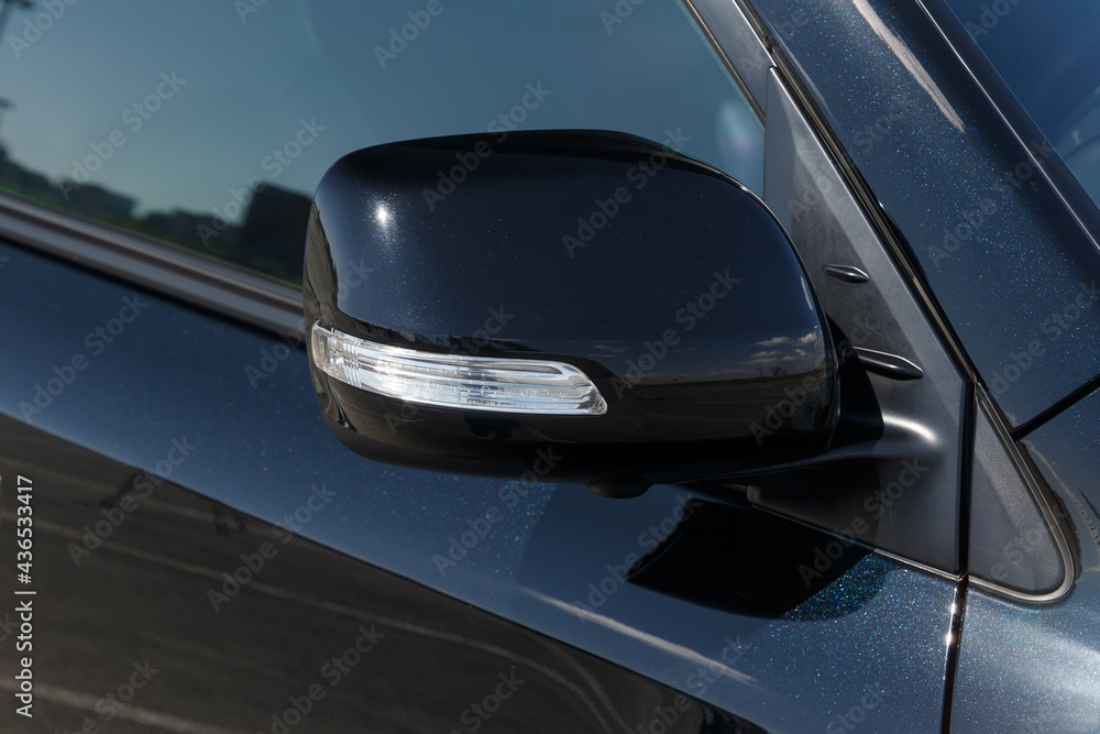 Side car mirror close-up. Details of luxury car. Car detail. Exterior details. Automotive concept. Classic black color Side car mirror close-up. Details of luxury car. Car detail. Exterior details. Automotive concept. Classic black color