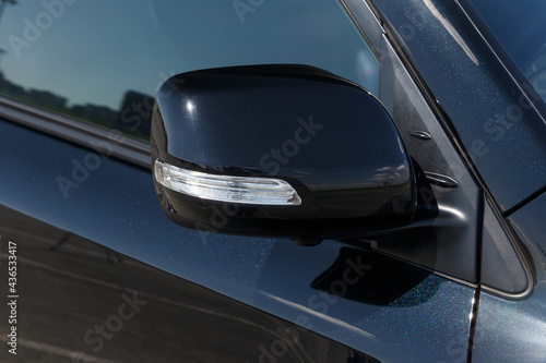 Side car mirror close-up. Details of luxury car. Car detail. Exterior details. Automotive concept. Classic black color © svetlichniy_igor
