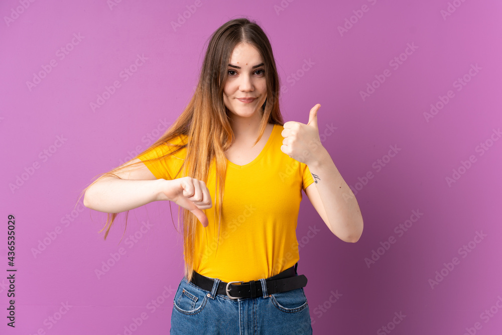 Young caucasian woman isolated on purple background making good-bad sign. Undecided between yes or not Young caucasian woman isolated on purple background making good-bad sign. Undecided between yes or not