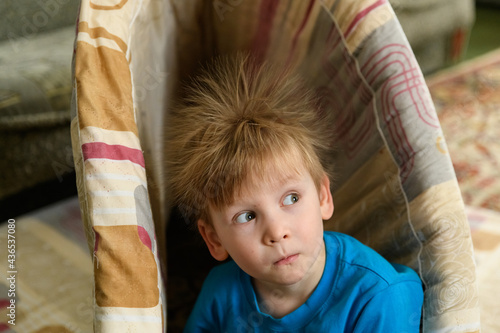 Portrait of smiling baby with standing hair from static electricity