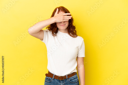 Teenager reddish woman isolated on yellow background covering eyes by hands. Do not want to see something