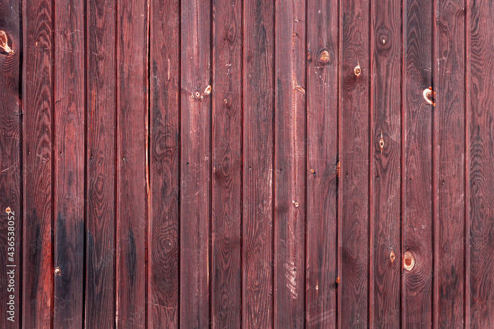 The old red wood texture with natural patterns The old red wood texture with natural patterns
