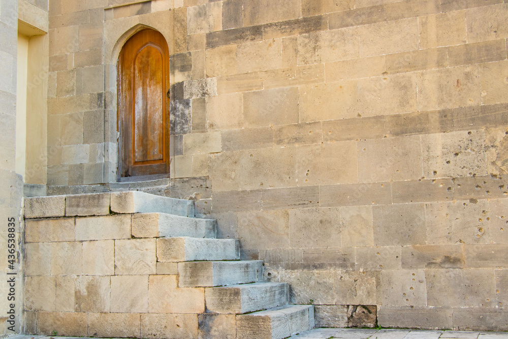 Medieval wooden door and stone staircase. View from Shirvanshahs Palace of Icheri sheher in Baku. Medieval wooden door and stone staircase. View from Shirvanshahs Palace of Icheri sheher in Baku.