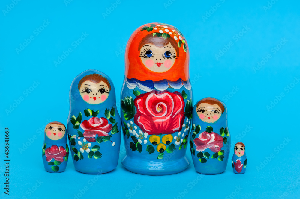 Matryoshka dolls on a blue background. Set of wooden toys Russian nesting dolls 