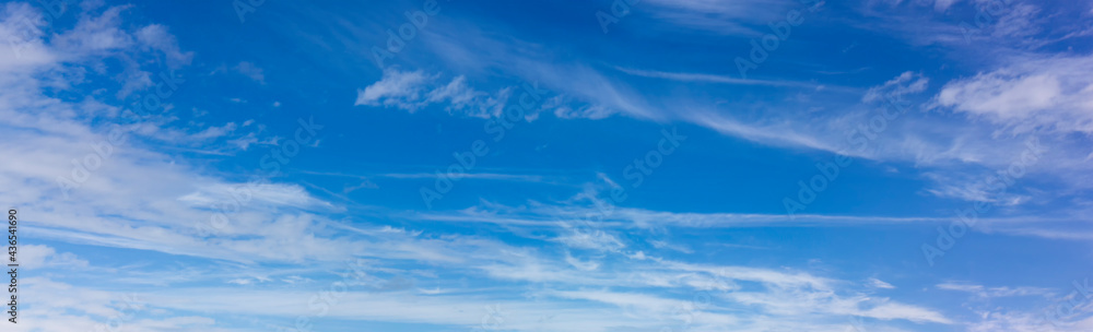 Panorama of blue sky with blurred white clouds. Abstraction of a cloudless clear sky.