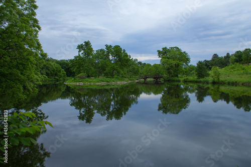 Lyman Lakes in Northfield, Minnesota with lush green vegetation and reflection of blue sky on water 