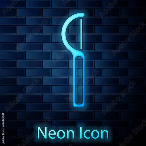 Glowing neon Dental floss icon isolated on brick wall background. Vector