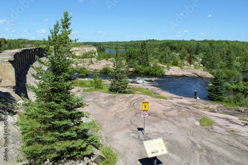 Pinawa Dam: Panoramic view of the river, stone bank and forest photo