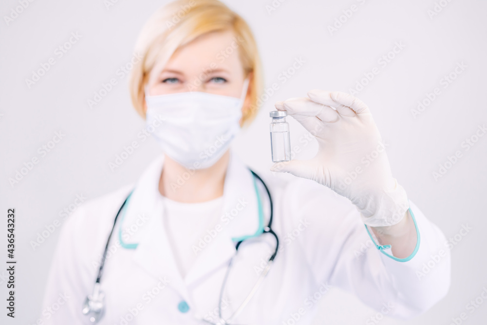Young attractive female nurse doctor holding clear liquid vaccin Young attractive female nurse doctor holding clear liquid vaccin