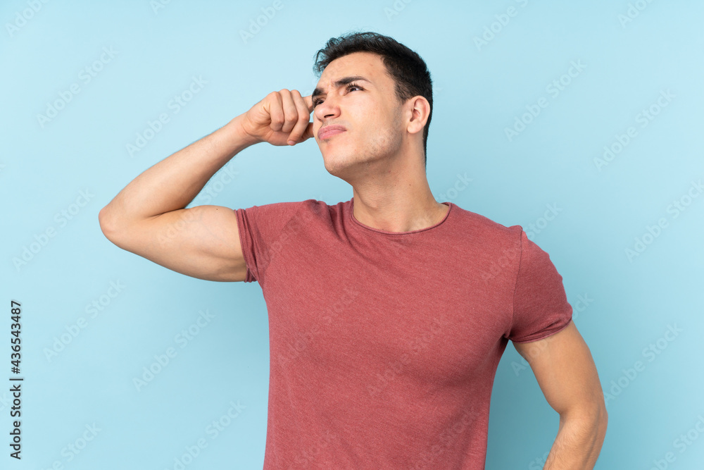 Young caucasian handsome man isolated on blue background having doubts and with confuse face expression Young caucasian handsome man isolated on blue background having doubts and with confuse face expression