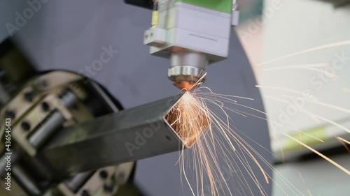 Laser cutting of metal pipe with sparks on tube laser machine