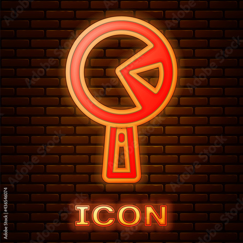 Glowing neon Omelette in frying pan icon isolated on brick wall background. Omelet in a skillet. Vector