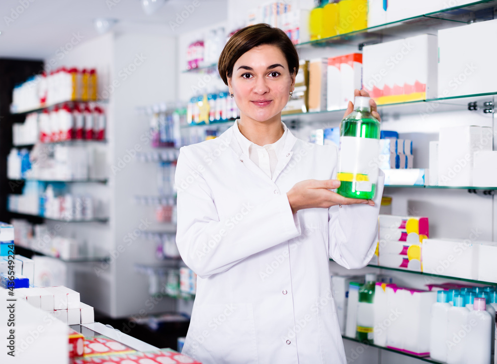 Woman is showing body care products in pharmacy.