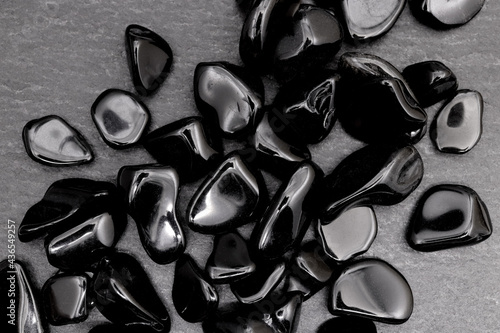 Obsidian heap up jewel stones texture on black stone background photo