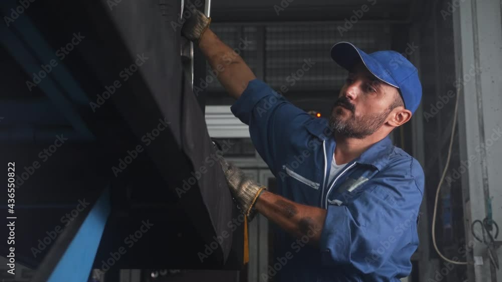 Young man is mechanic repair tires wheel car in the garage with professional, auto service, maintenance and technician, automobile examining and fix, male diagnostics and inspection automotive. Young man is mechanic repair tires wheel car in the garage with professional, auto service, maintenance and technician, automobile examining and fix, male diagnostics and inspection automotive.