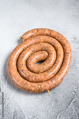 Raw spiral sausage from pork and beef mince meat. White background. Top view