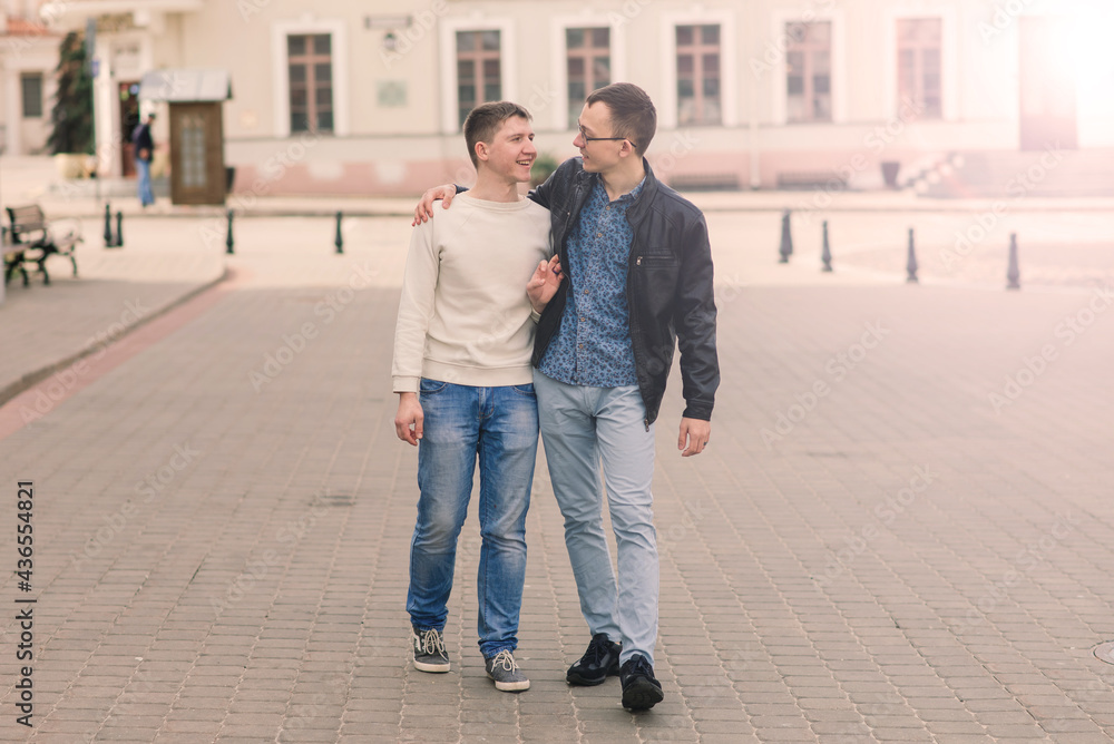 Cute gay couple in the city, tender gentle kissing, smiling