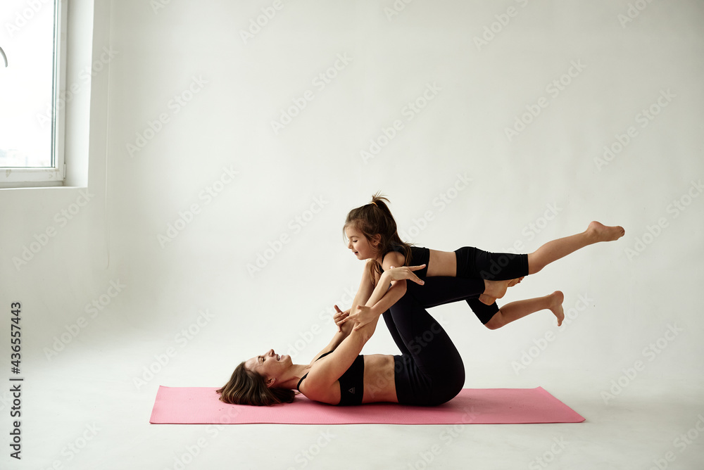 Fototapeta premium mother and daughter doing yoga together
