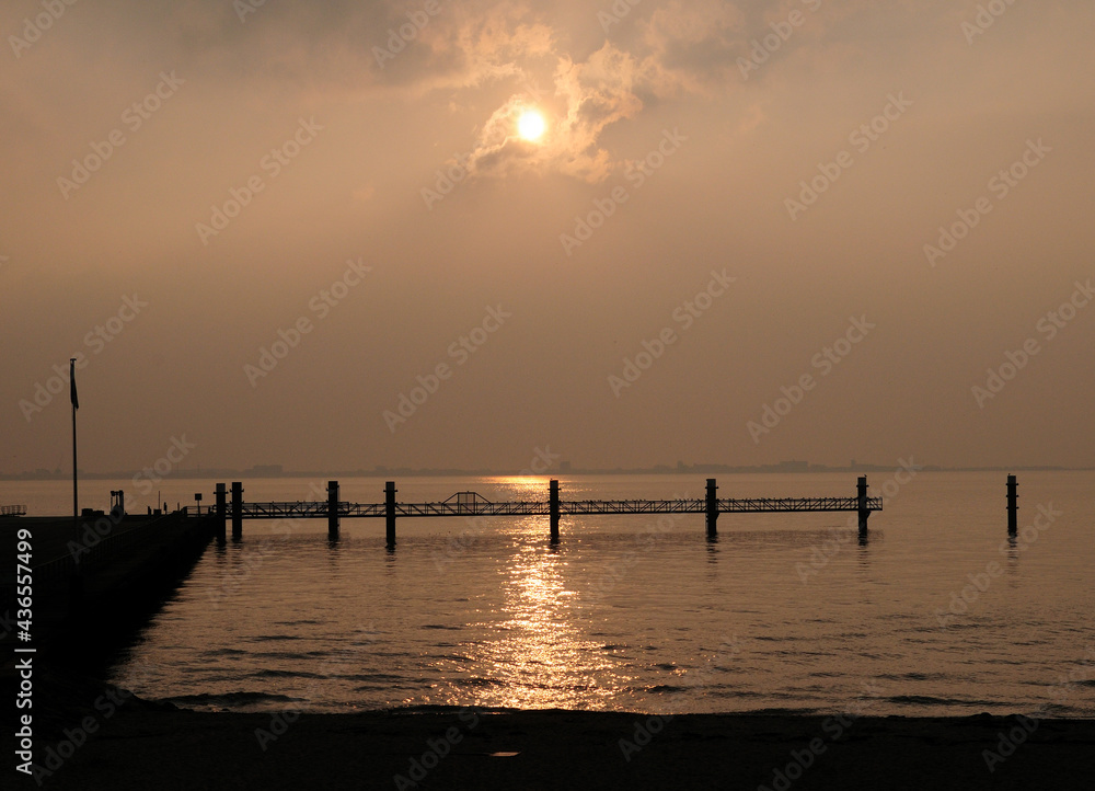 Late Afternoon Sun Reflecting On The Dollart Bay At The North Sea Coast Near Emden East Frisia On A Sunny Autumn Day Late Afternoon Sun Reflecting On The Dollart Bay At The North Sea Coast Near Emden East Frisia On A Sunny Autumn Day
