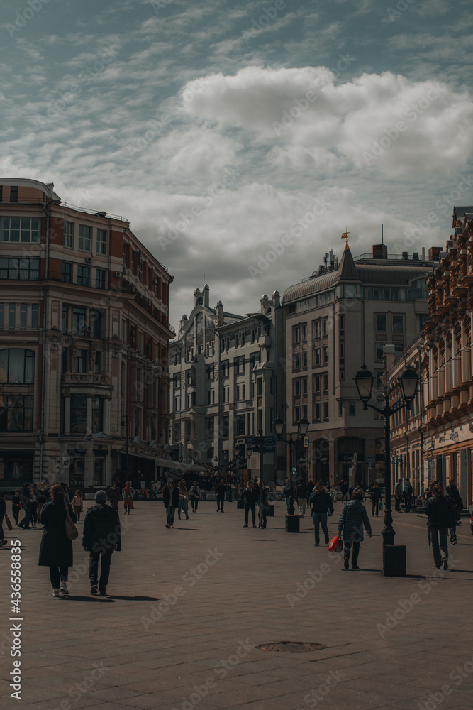 Obraz premium Center of Moscow with historic vintage buildings and walking people. Toned vertical photo