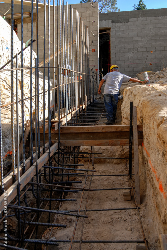 Installing vertical rebar on a new structural footing Stock Photo