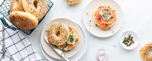 Photos Narrow view of Everything bagels with cream cheese, smoked salmon lox and garnished with capers and sprouts