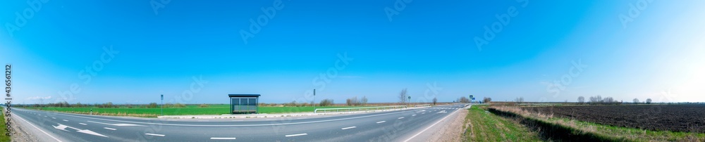 stop for passengers near the road on a background of blue sky