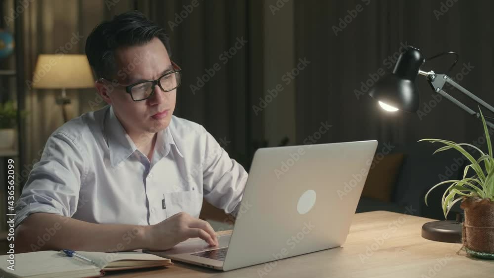 Tired Asia Man While Working From Home At Living Room At Night