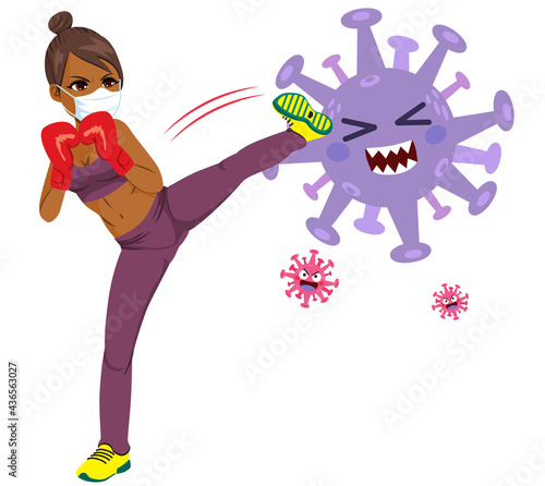 Young black African American woman kicking big coronavirus character fight pandemic concept