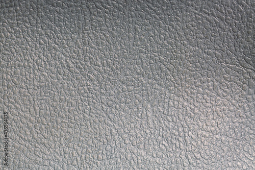 Gray textured leather background. Silver metallic foil texture