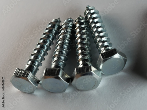 Closeup shot of lag screws on a white surface