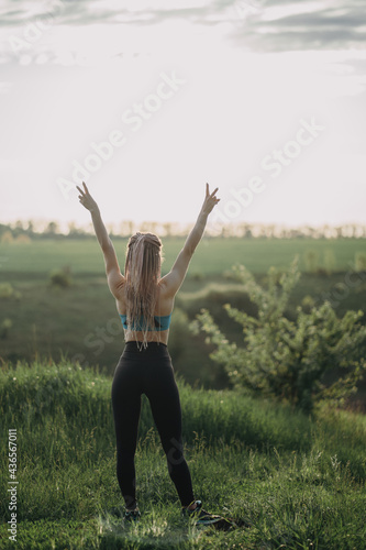 Sporty fit woman raising arms express positivity